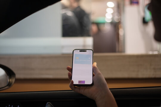 paying with phone at drive thru fast food restaurant