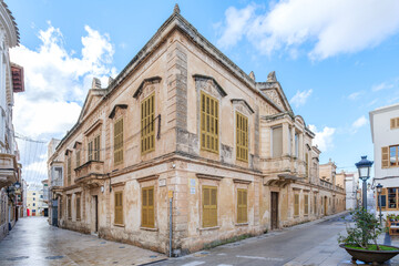 Historic Stone Building on a Corner Street in Ciutadella de Menorca. Traditional Spanish architecture, charming urban landscape, Mediterranean island, travel destination