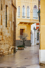 Charming Narrow Street in Ciutadella de Menorca with Traditional Architecture. Historic alleyway, Mediterranean town, colorful buildings, Spanish urban landscape, travel destination