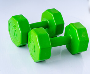 Two dumbbells 2 kg each. Sports equipment. White background. Green set.
