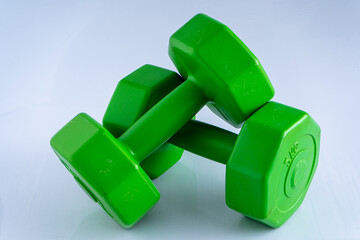 Two dumbbells 2 kg each. Sports equipment. White background. Green set exercise