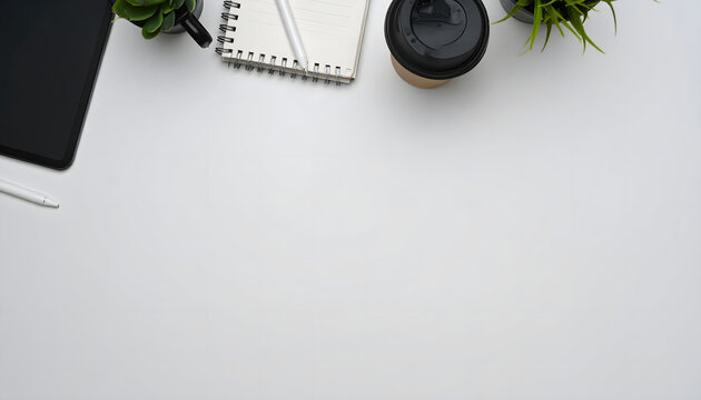 Clean workspace featuring a tablet, notebook, pen, coffee cup, and small plants on a bright white table ideal for productivity blog posts, website banners, or office stationery advertisements.