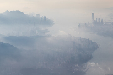 Aerial view from a Cathay Pacific plane over the various Islands of Hong Kong and the financial district with many high-rise skyscrapers creating a dense country
