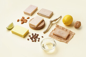 Composition with soap bars and natural ingredients on color background
