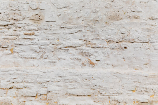 white rustic sandstone rendered wall