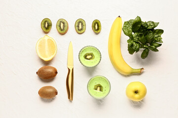 Glasses of fresh kiwi smoothie with banana and basil on white background
