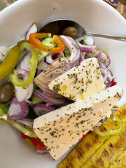 Greek salad with olives, cucumbers, onions and feta cheese vertical