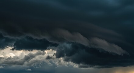 Naklejka premium Dramatic, ominous dark clouds gathering in a stormy sky, conveying a sense of foreboding and change