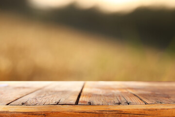 Empty rustic table in front of countryside background. product display and picnic concept