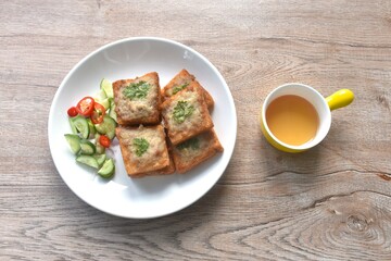 Thai crispy fried pork toast on plate eat couple with pickled vegetable sauce