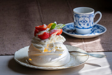 Mini Pavlova with strawberry. Tasty Pavlova Dessert with strawberry. Summer aesthetics vibes background. Meringue-based dessert. 