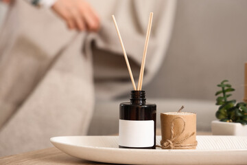 Reed diffuser on table at home, closeup