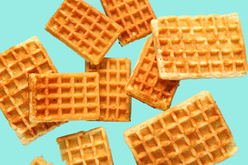 Falling waffles on light blue background