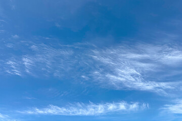 Light white clouds on bright blue gradient sky, background, backdrop, screensaver, screen, desktop.