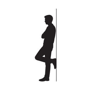 Silhouette of man standing relaxed, leaning back against wall