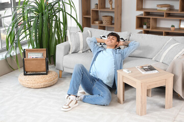 Fototapeta premium Handsome young man resting with air conditioner on at home