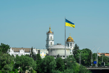 Ukrainian flag against the background of the crosses of an Orthodox church. Summer, 2025.