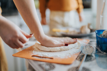 Hands pressing dough on a cutting board in a cozy kitchen, showcasing the joy of homemade cooking...
