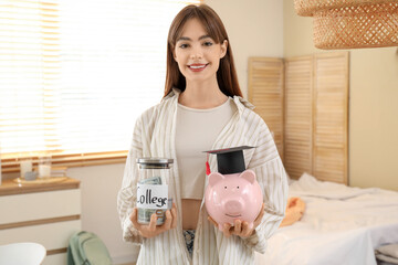 Female student with jar of money for college and piggy bank at home. Education savings concept