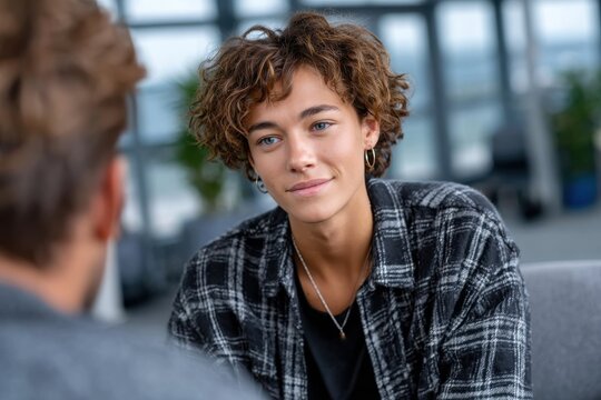A young person thoughtfully engages in conversation, expressing curiosity and deep contemplation while listening intently, revealing the importance of connection and understanding.