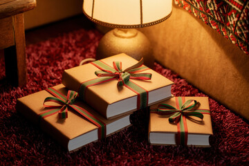 Cozy christmas books wrapped in festive ribbon on a warmly lit table