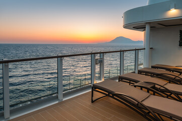 Luxury Cruise Ship Deck with Outdoor Loungers at Sunset