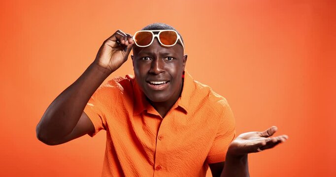 Black man, sunglasses and surprise with face in studio with questions, confused and fashion by background. African person, wow and shock for deal, portrait and style with mock up space in Nigeria