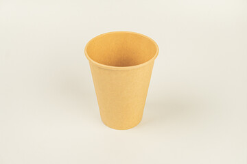 A minimalistic image featuring a single-serve light browncream coffee cup on a flat surface