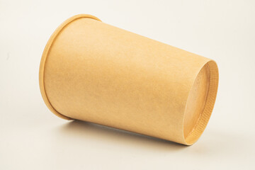 Image depicts a textured, cylindrical object possibly made of fabric or paper, with an opening It could serve as a storage tool like a pencil holder or decorative item Background is light