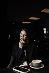 young woman drinking coffee in cafe