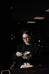 young woman drinking coffee in cafe