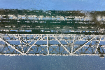 Reflection of white bridge structures and blue sky in water. Beautiful background, backdrop, screen, desktop.