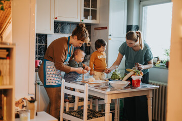A group of people gathered around a kitchen preparing food together, emphasizing connection and...