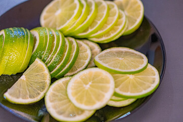 Image showcases a vibrant display of fresh citrus fruits - limes and lemons, with juicy segments...
