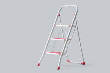 Red stepladder on light background