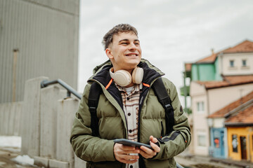 Young adult caucasian man student smile and use phone to take self portrait or video call	
