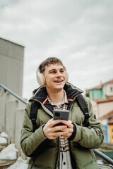 Young adult caucasian man student smile and use phone to take self portrait or video call	
