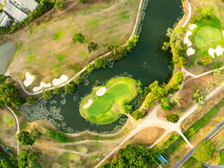 Aerial view drone shot of beautiful green golf field fairway and putting green,Top down image for sport background and travel nature background.