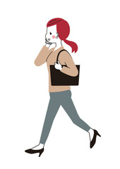 スマートフォンで通話しながら通勤する若い女性