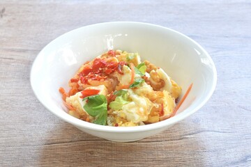 spicy batter slice fried egg with tomato and shallot Thai salad on bowl