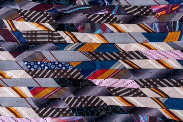 Patchwork quilt Blanket. A fragment of colorful pieces of fabric sewn together.