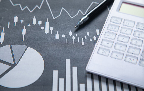 Pen and calculator on a financial graphs. Business