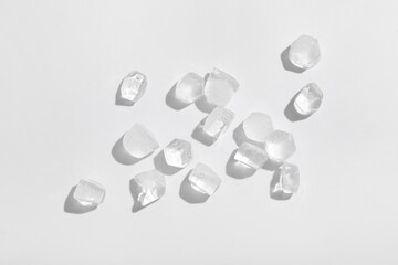 Frozen ice in shape of hexagon on grey background