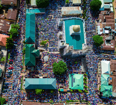 Aerial view of thousands of worshippers gather for Eid prayer in a vibrant display of faith and community at Dan Fodio Mosque in Unguwan Sunusi, Kaduna, Nigeria.