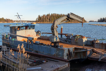 Transport ferry with palfinger crane, Old dredging boat with arm, hydraulic engineering and maritime transport