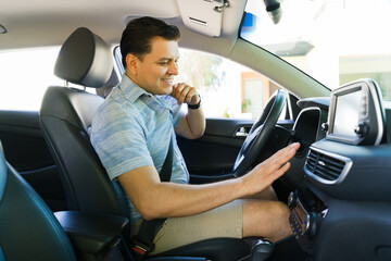 Smiling driver adjusting air conditioning for comfort