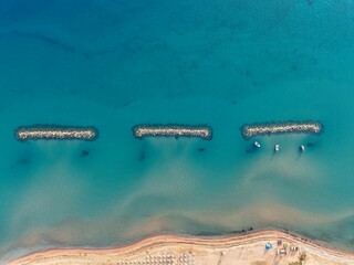 Aerial View of Coastal Rock Formation Above Turquoise Sea