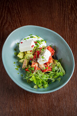 A delightful mix of greens, tomatoes, and cucumbers topped with creamy dressing and herbs