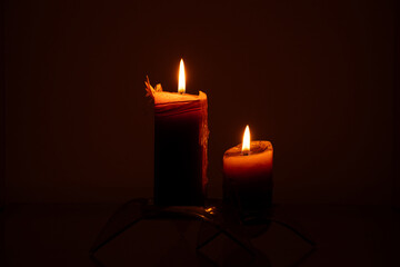 Candles in the dark close-up on a dark background