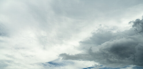Dramatic overcast sky panorama with gray storm clouds during rainy season. Moody atmospheric...